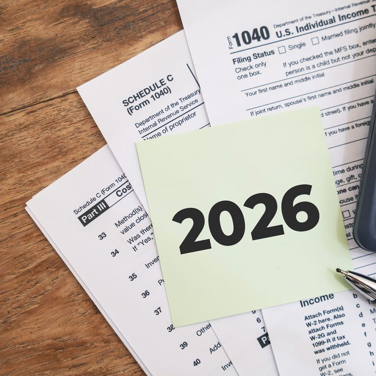 2026 numbers on the note paper with calculator and taxes documents. Marketing materials related to tax filing or fiscal year deadlines